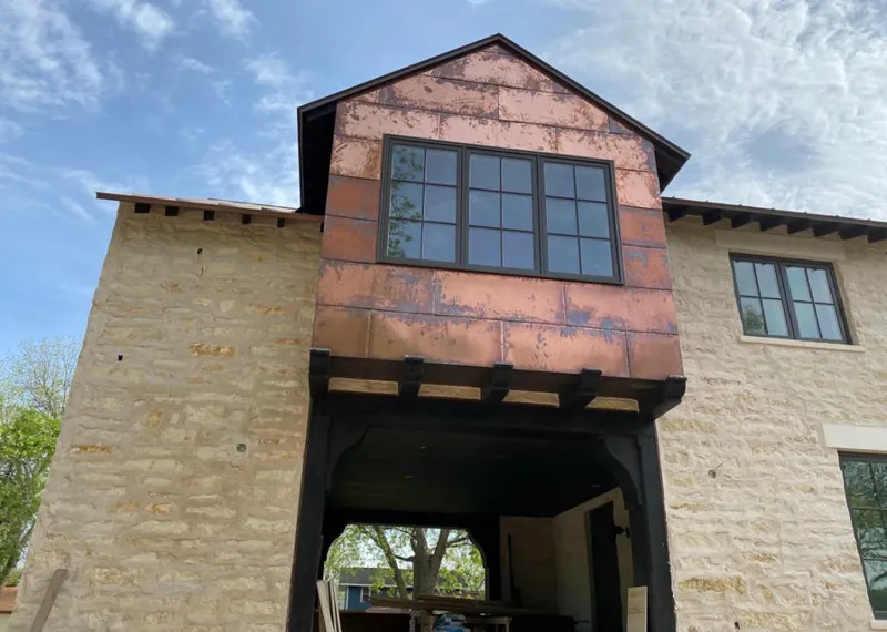 Copper metal panel facade on a stone building for Metal Roof Coating in Oscoda