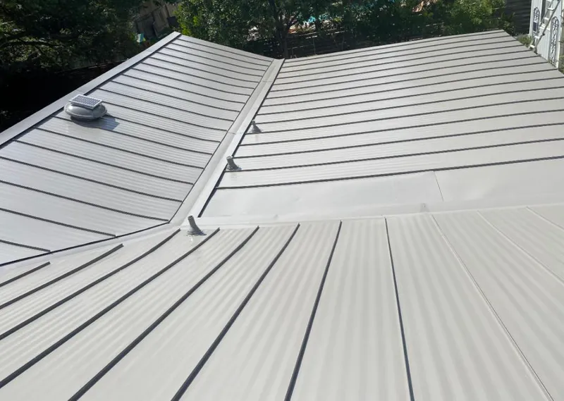 Solar attic fan installed on a metal roof for Roof Ventilation in Oscoda